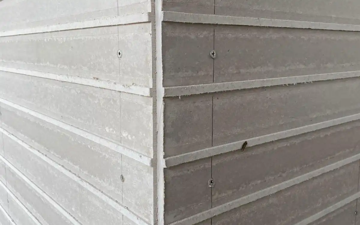 Brick slip backing board being mechanically fixed to the Superstrux™ extension wall elevation