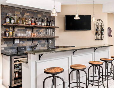 Home bar extension with backlit shelving, bar stools, and atmospheric lighting — Betta Space
