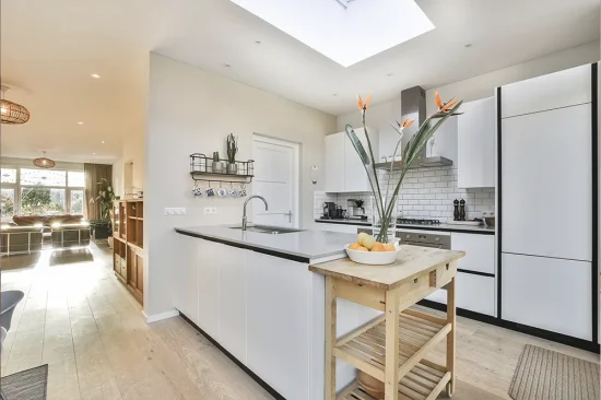 Bright open-plan kitchen extension with bifold doors opening onto a garden