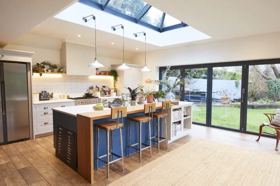 Open-plan living and dining extension with large rear window and garden view